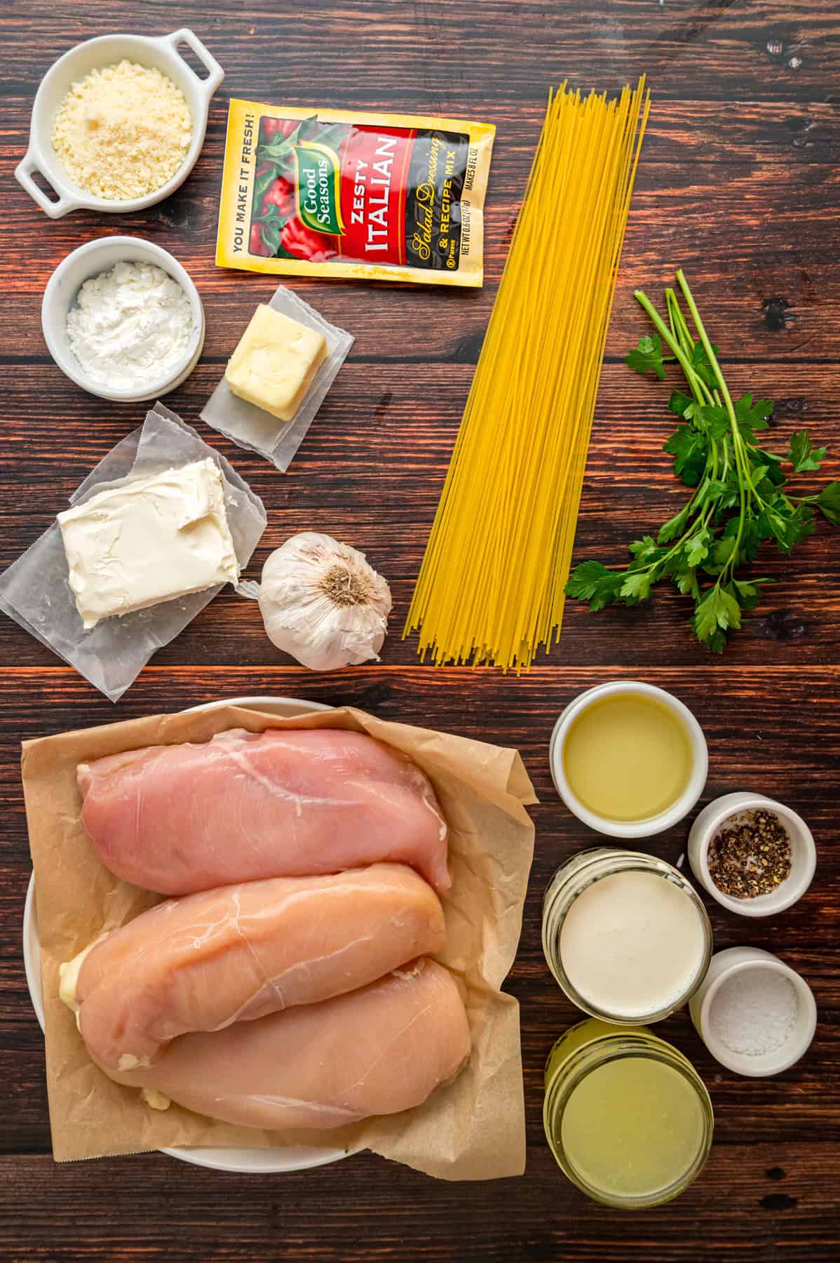 Chicken breasts are slow-cooked in a creamy sauce and served over pasta in this Angel Chicken recipe. A family favorite! Overhead view of ingredients for angel chicken