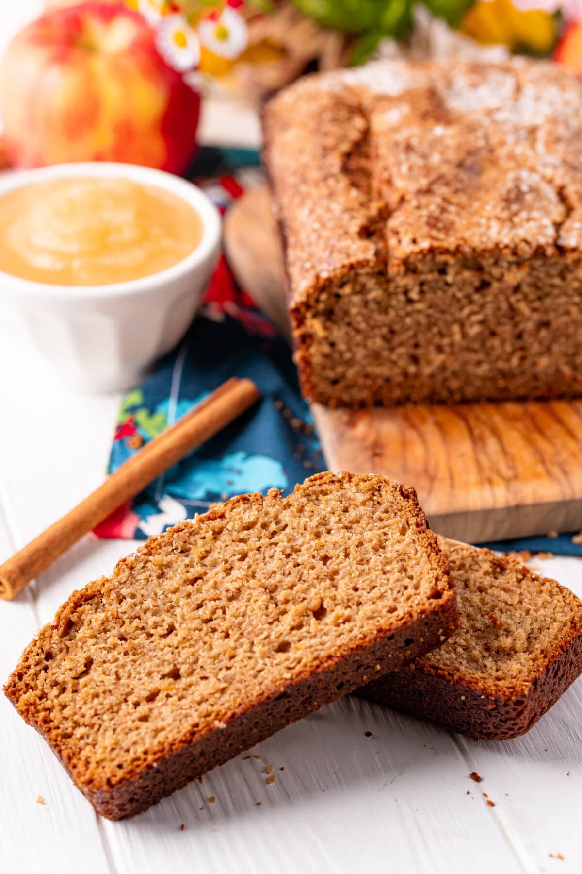 slice of applesauce bread with the loaf behind it