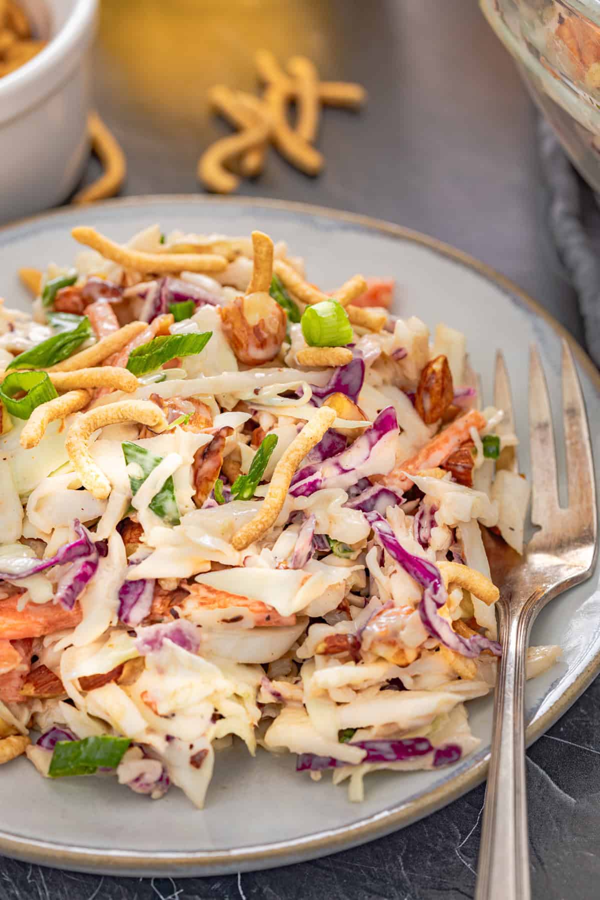 With ingredients like sweet chili sauce, ginger, and soy sauce, this Asian Coleslaw is not your basic coleslaw. Quick and easy! A plate of Asianc oleslaw