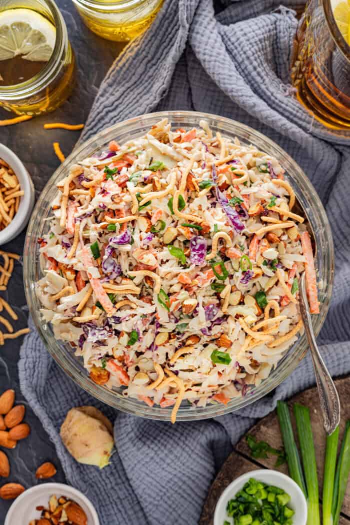 With ingredients like sweet chili sauce, ginger, and soy sauce, this Asian Coleslaw is not your basic coleslaw. Quick and easy! Overhead view of a bowl of Asian coleslaw