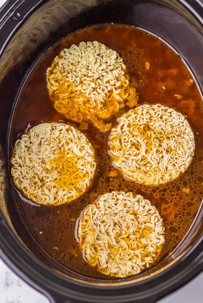 Tender birria beef slow cooks all day before getting tossed with ramen noodles and toppings in this Birria Ramen recipe. Ramen added to a slow cooker with birria meat