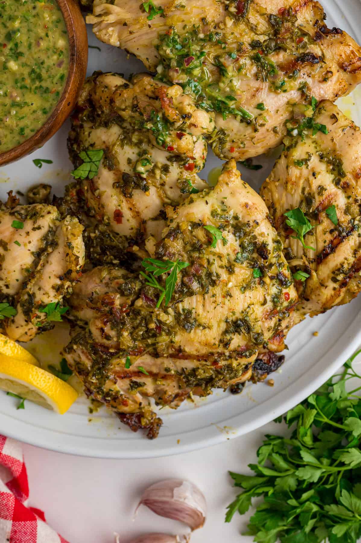 Chicken thighs are marinated in a chimichurri sauce then cooked to tender, juicy perfection in this Chimichurri Chicken recipe. Chimichurri chicken on a plate