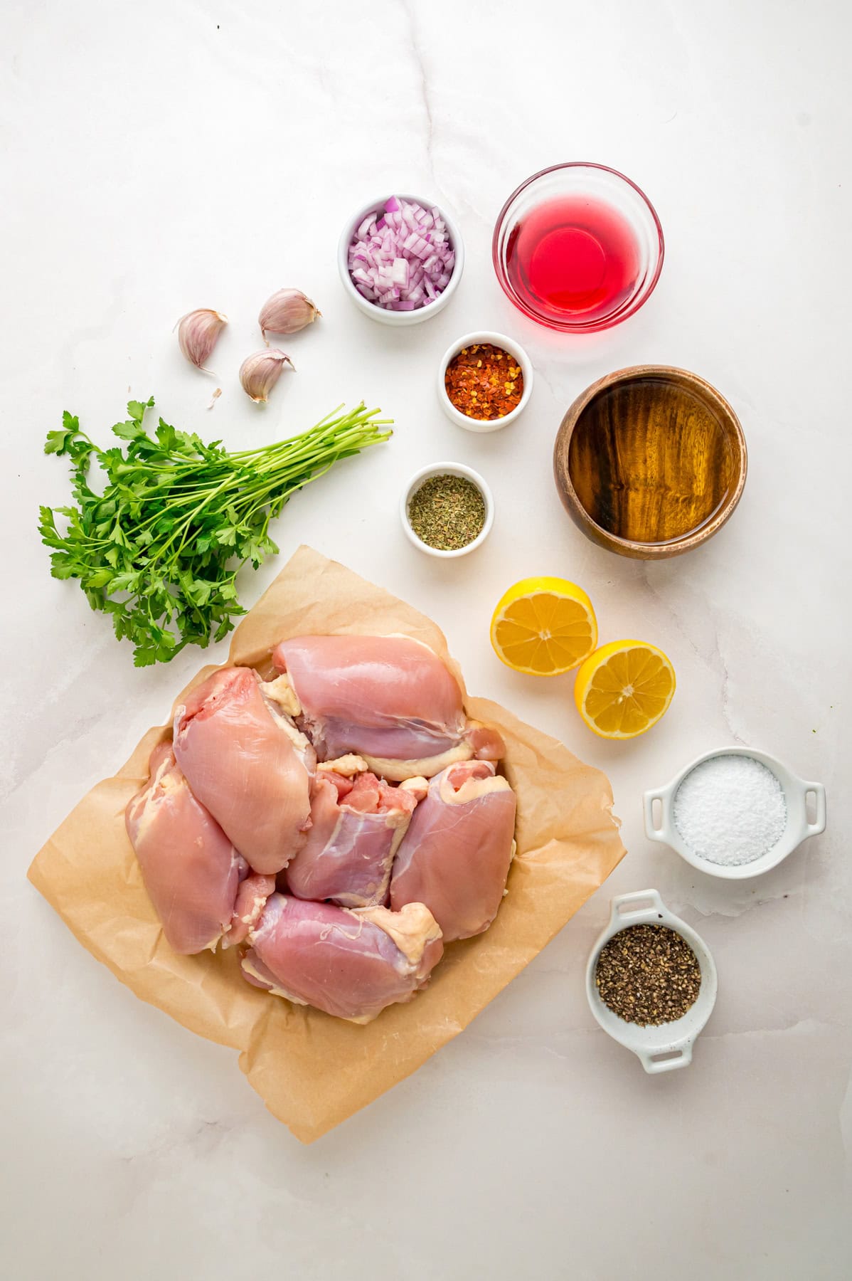 Chicken thighs are marinated in a chimichurri sauce then cooked to tender, juicy perfection in this Chimichurri Chicken recipe. Overhead view of ingredients needed to make chimichurri sauce