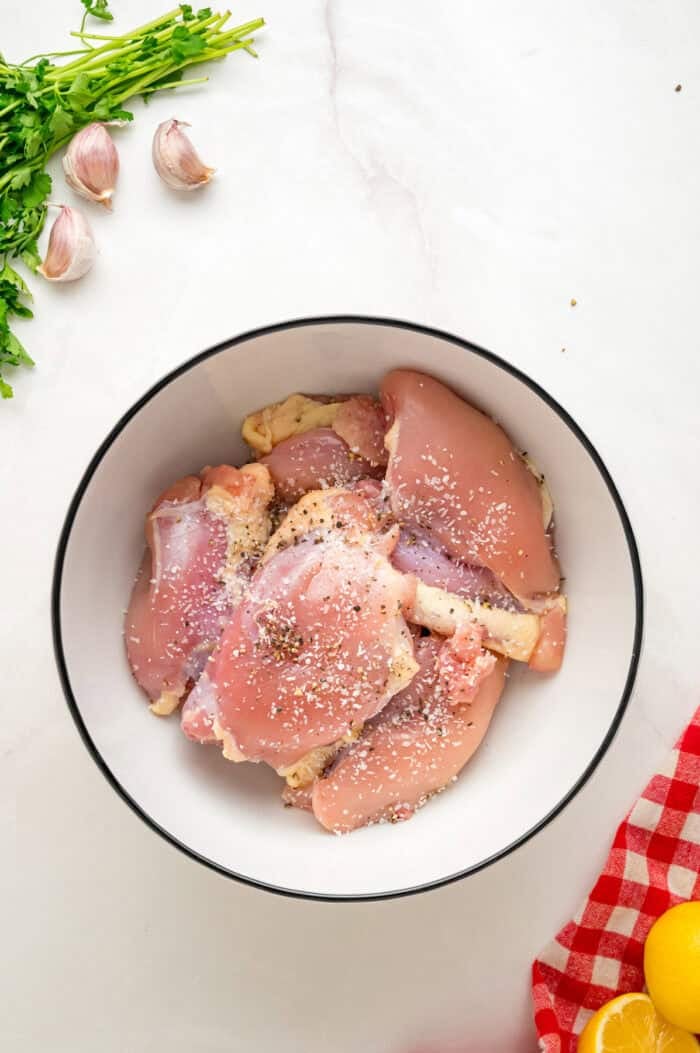 Chicken thighs are marinated in a chimichurri sauce then cooked to tender, juicy perfection in this Chimichurri Chicken recipe. Chicken thighs in a bowl