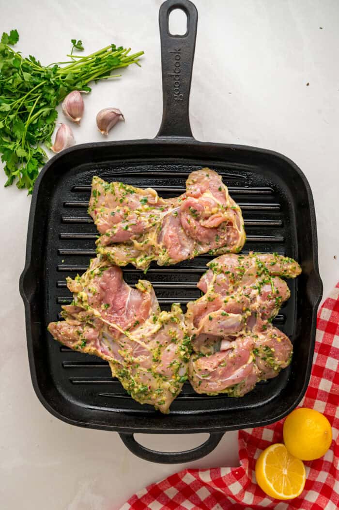 Chicken thighs are marinated in a chimichurri sauce then cooked to tender, juicy perfection in this Chimichurri Chicken recipe. Marinated chicken on a grill pan