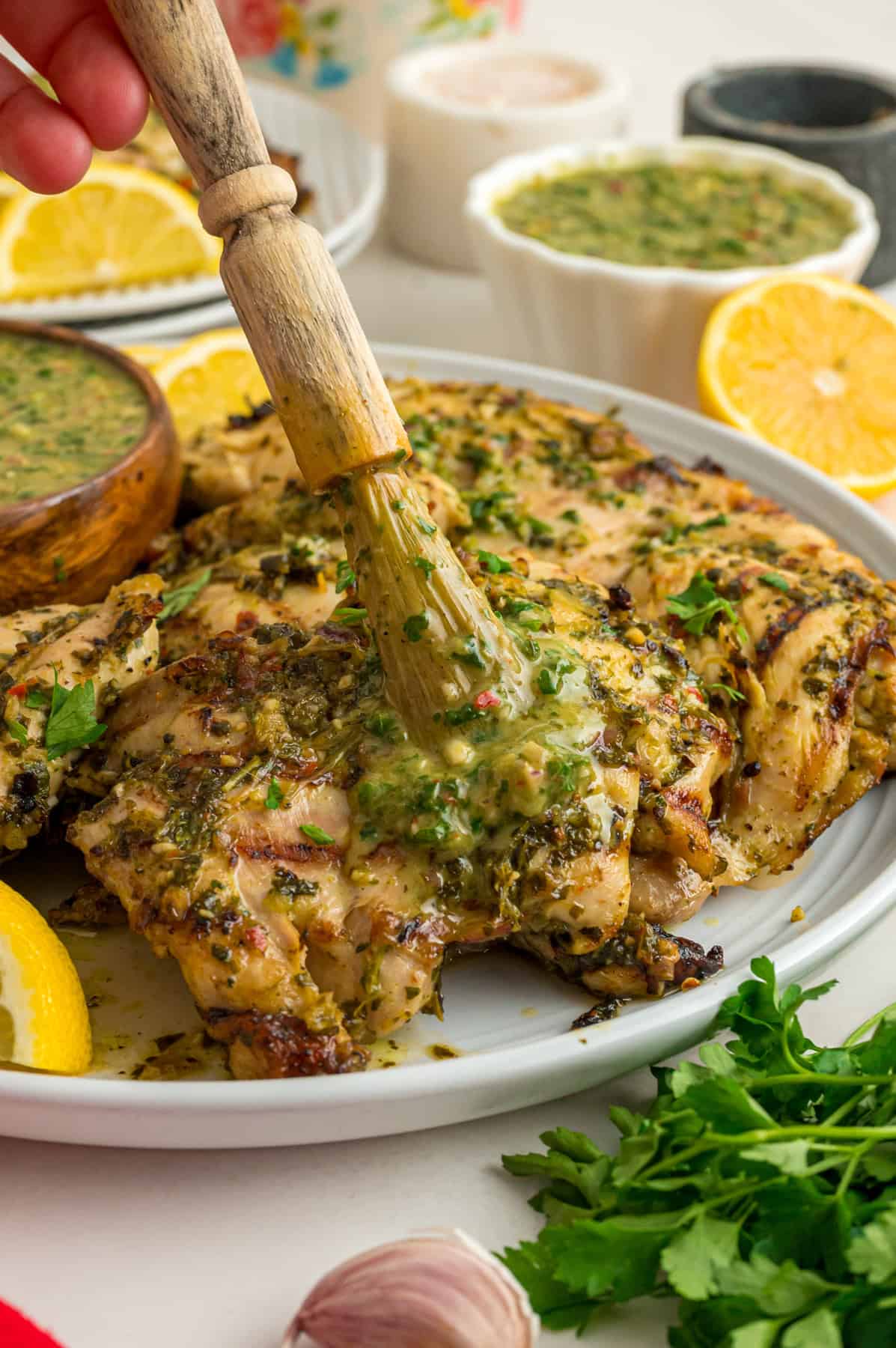 Chicken thighs are marinated in a chimichurri sauce then cooked to tender, juicy perfection in this Chimichurri Chicken recipe. Basting chimichurri chicken