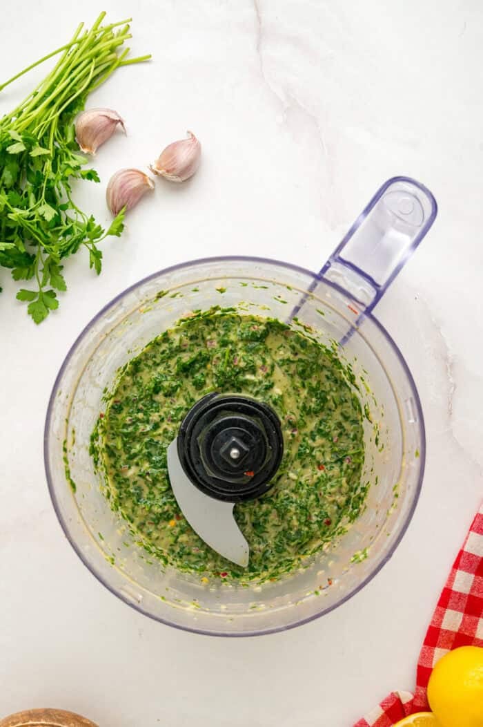 Chicken thighs are marinated in a chimichurri sauce then cooked to tender, juicy perfection in this Chimichurri Chicken recipe. Chimichurri sauce in a food processor