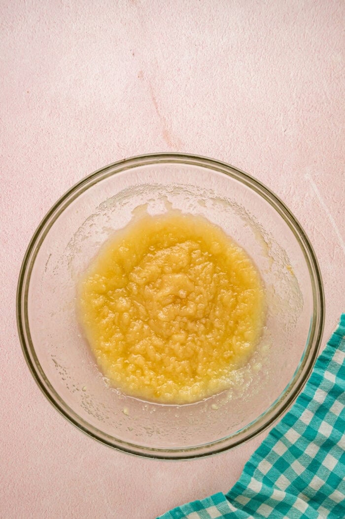 With dense, chewy brownies topped with frosting and rainbow candy-coated chocolate chips, these Cosmic Brownies are a nostalgic treat. Sugar and melted butter n a bowl