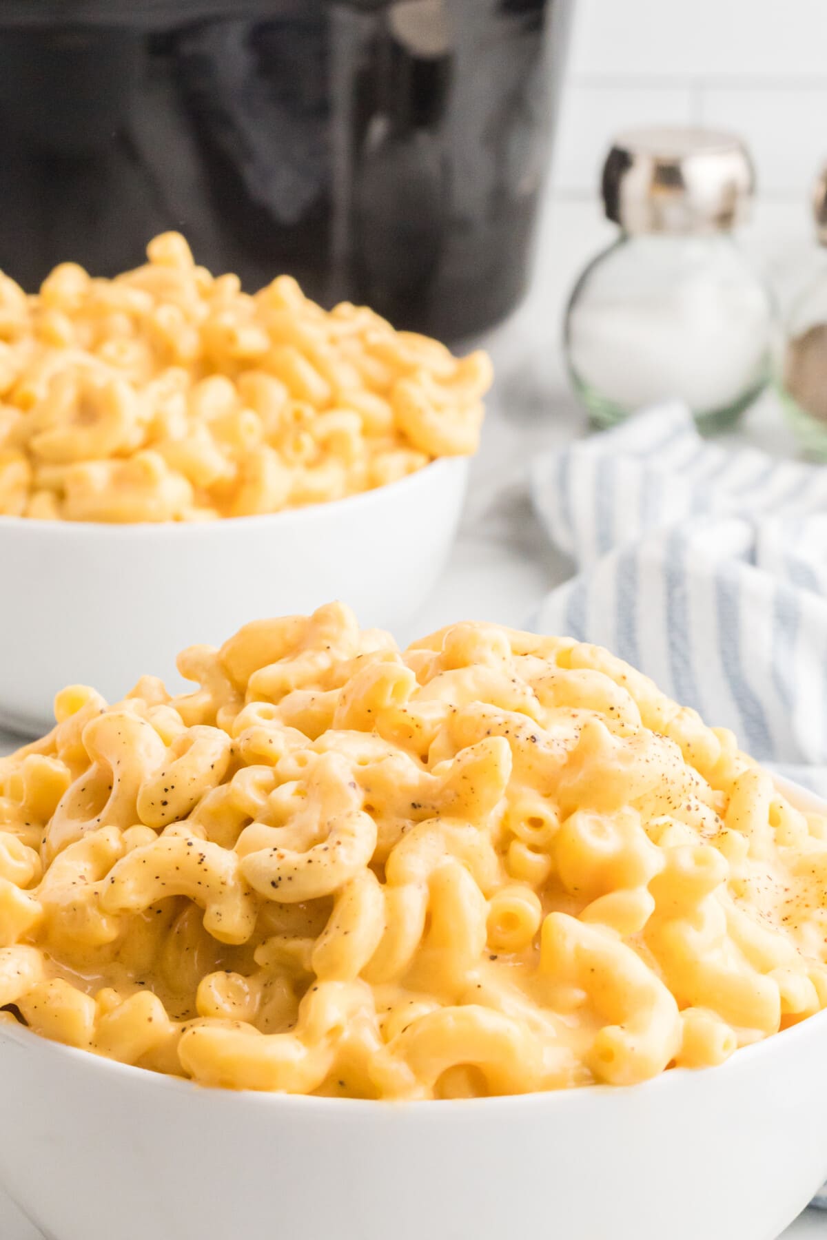 Made with a mix of cheddar and American cheeses, this Crock Pot Mac and Cheese is uber creamy and super easy to make. Crockpot Mac and Cheese in a bowl