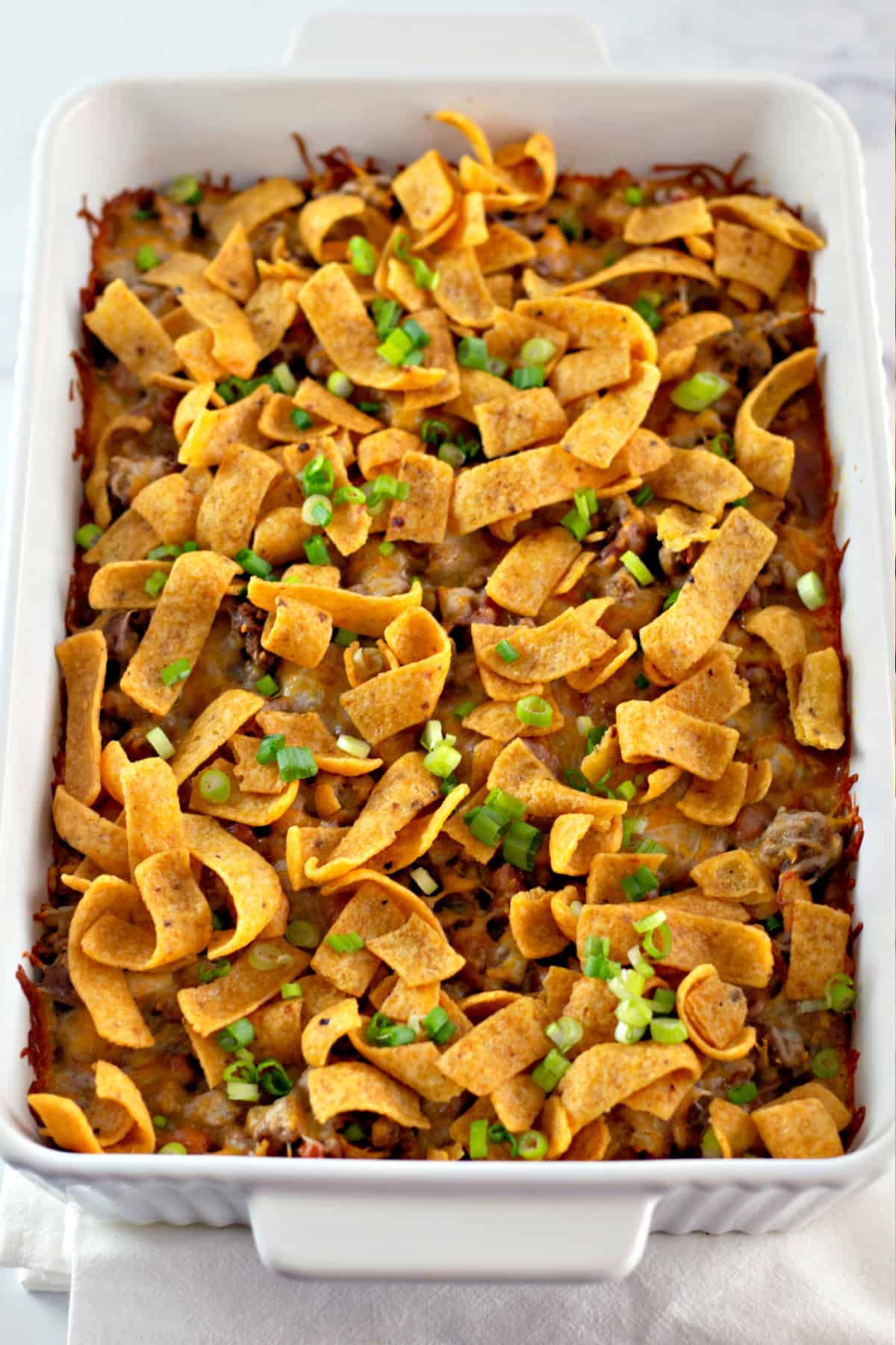 You'll love this Easy Frito Pie Recipe for a family-friendly dinner in a snap! baked frito pie