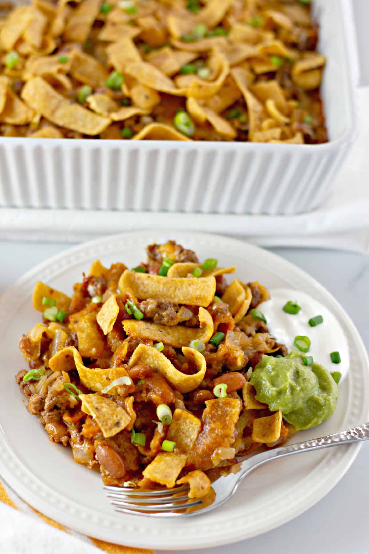 You'll love this Easy Frito Pie Recipe for a family-friendly dinner in a snap! Frito Pie on a plate