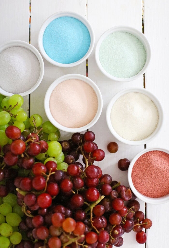 Candy Grapes are frozen grapes dipped and coated in a thin layer of vibrant and flavored Jello mix. grapes and jello powder