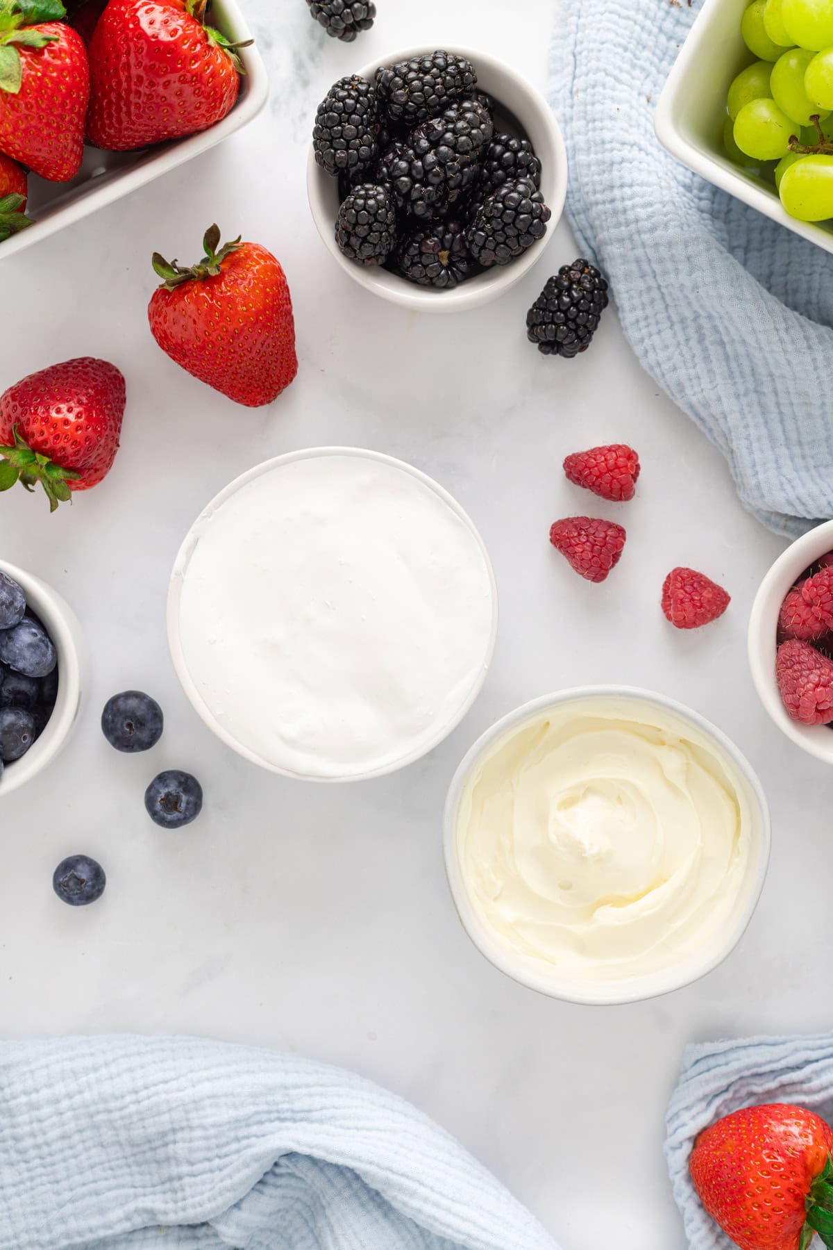 Light and creamy, this 2-Ingredient Fruit Dip is the perfect treat for summer! Serve with fresh fruit for a quick and easy dessert. Overhead view of ingredients needed to make fruit dip