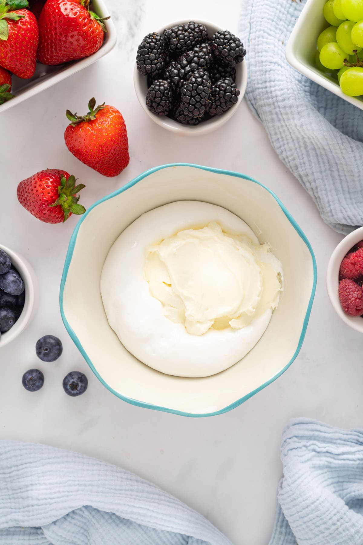 Light and creamy, this 2-Ingredient Fruit Dip is the perfect treat for summer! Serve with fresh fruit for a quick and easy dessert. Cream cheese and marshmallow creme in a bowl
