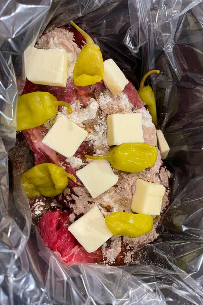 Mississippi Pot Roast is a flavor explosion of slow-cooked chuck roast, ranch seasoning, au jus seasoning, pepperoncini, and butter. Mississippi pot roast ingredients in the slow cooker