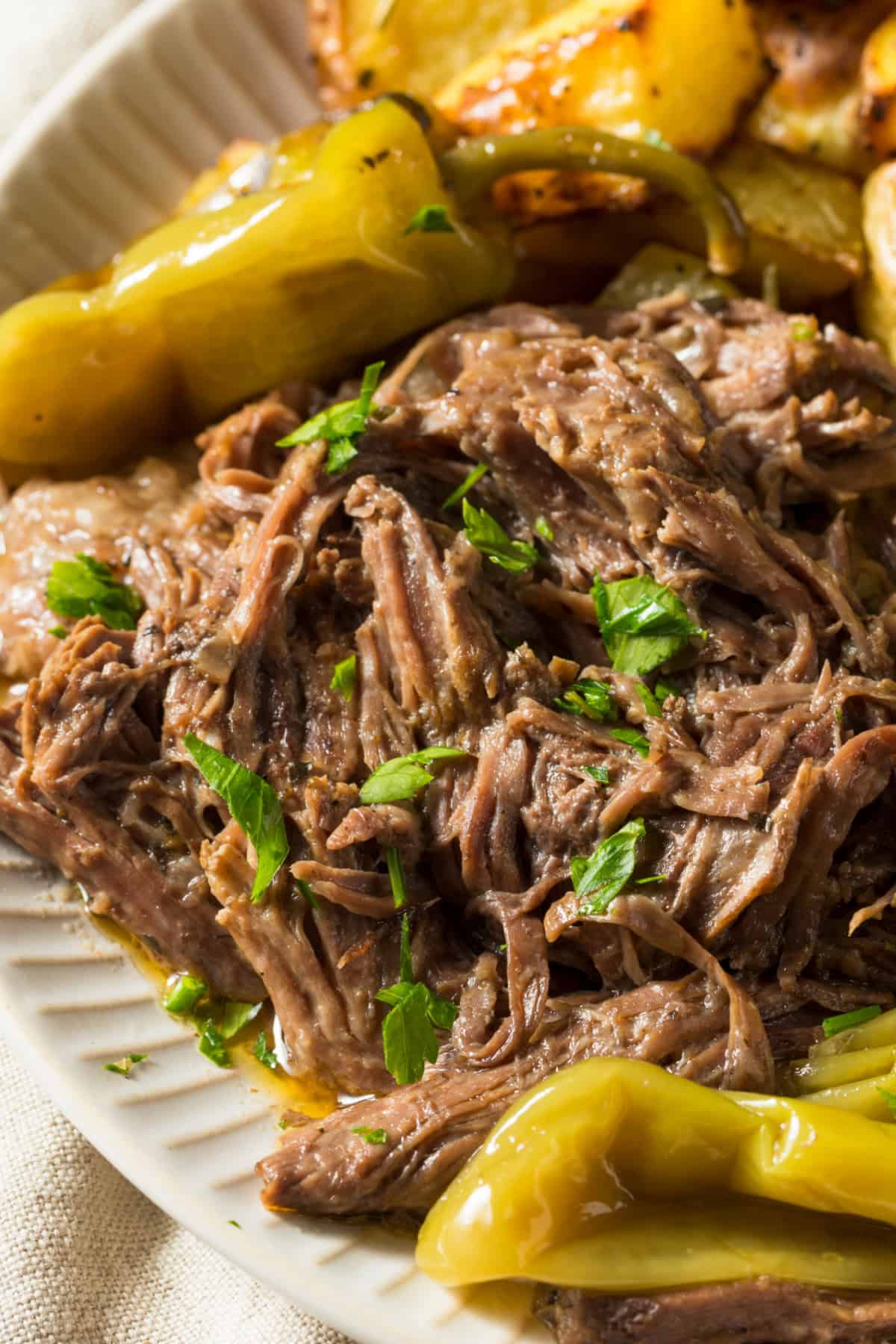 This easy Mississippi Pot Roast recipe is 100% the best! Made with only 5 ingredients and perfect with fluffy mashed potatoes. Mississippi Pot Roast on a plate