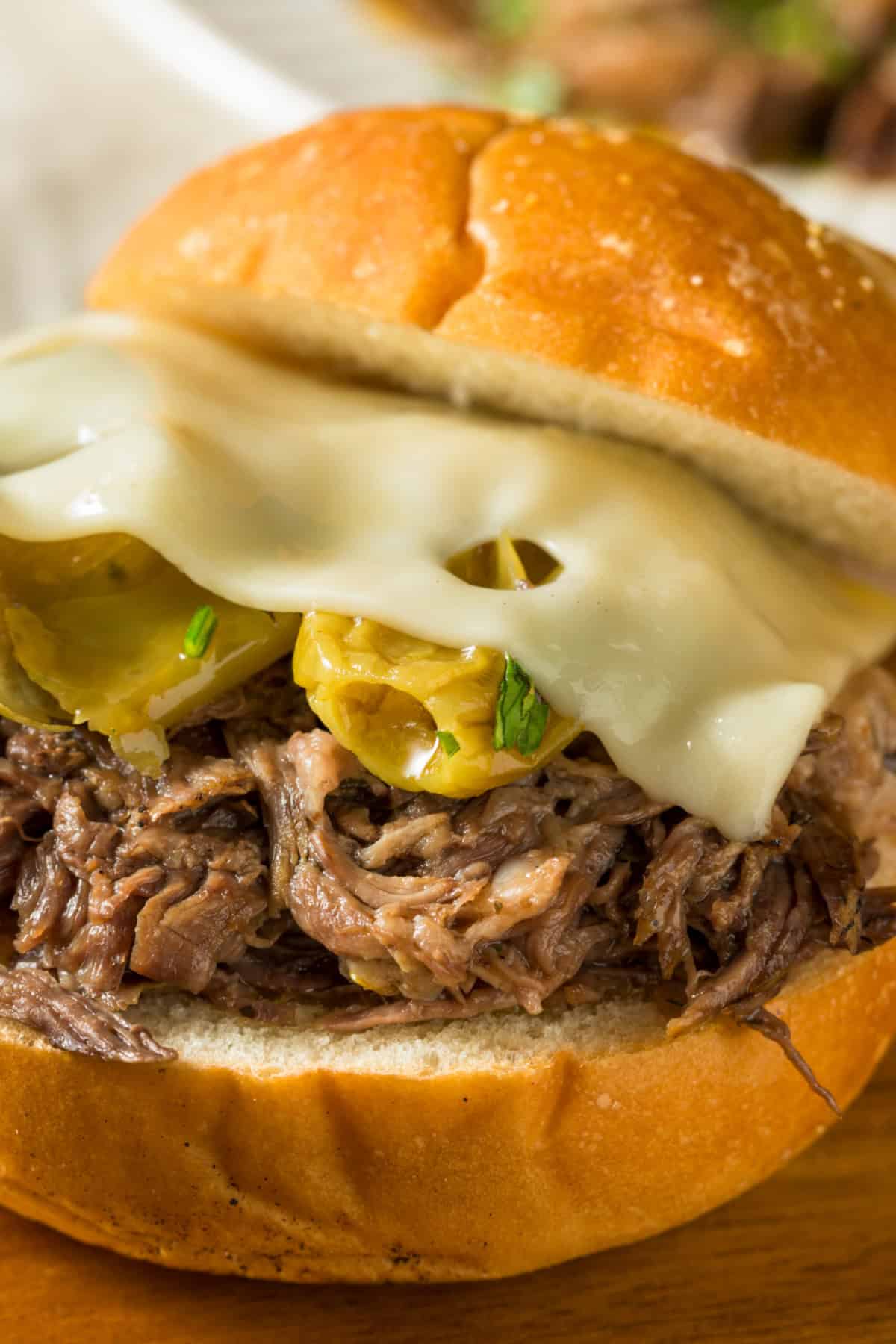 This easy Mississippi Pot Roast recipe is 100% the best! Made with only 5 ingredients and perfect with fluffy mashed potatoes. showing the inside of a Mississippi Pot Roast Sandwich