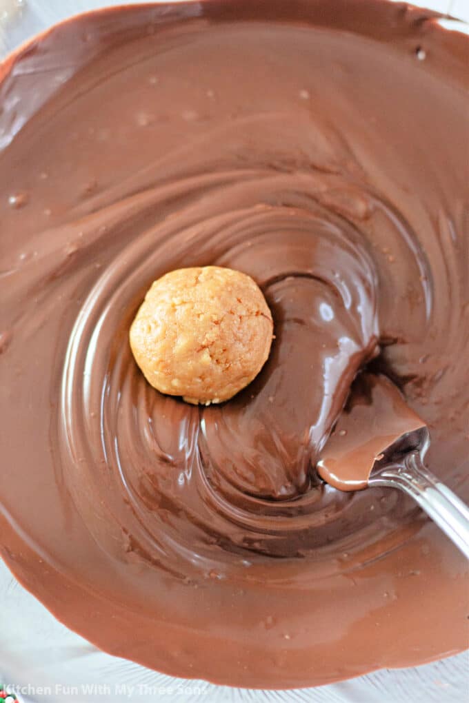 dipping the truffles into melted chocolate.