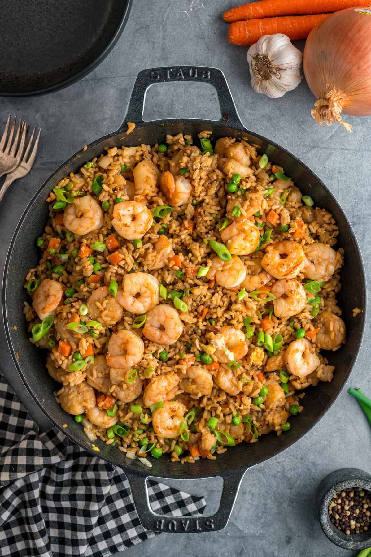 With juicy shrimp, veggies, and scrambled egg, this Shrimp Fried Rice recipe is better than takeout! Ready in just 30 minutes! Overhead view of a pan of shrimp fried rice