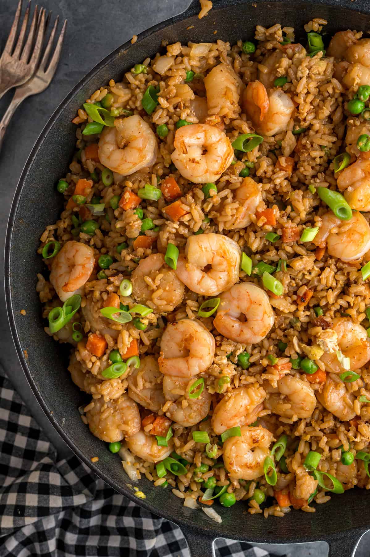 With juicy shrimp, veggies, and scrambled egg, this Shrimp Fried Rice recipe is better than takeout! Ready in just 30 minutes! Overhead view of a pan of shrimp fried rice
