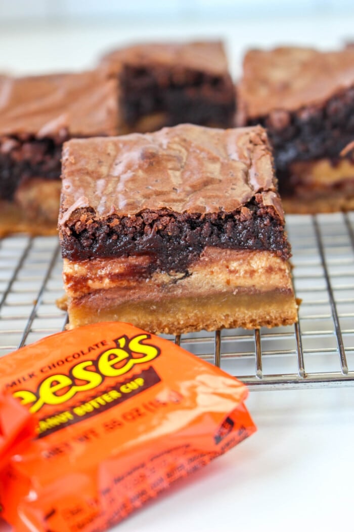 Slutty Brownies with a packaged reese's cup next to it.