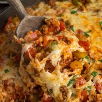 A serving spoon in stuffed pepper casserole